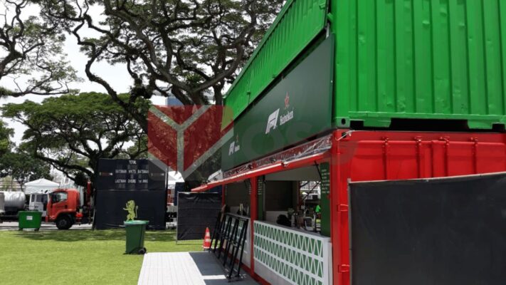 Colorful shipping containers set up in an outdoor event space.