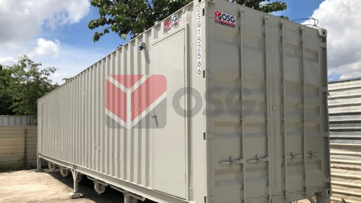 A large, gray shipping container with a company logo.