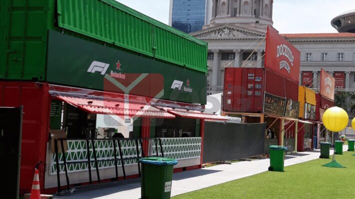 Colorful shipping containers set up for an outdoor event.