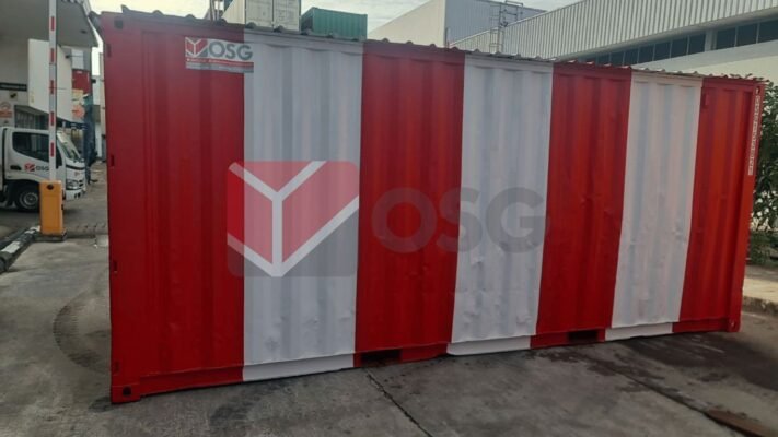 Red and white shipping container in an urban setting.