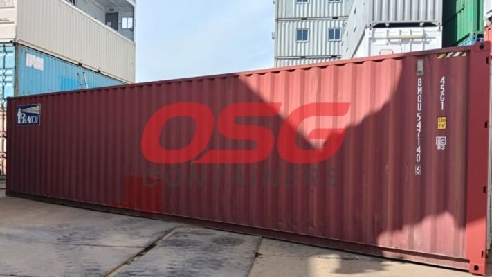 A large red shipping container with a logo on its side.