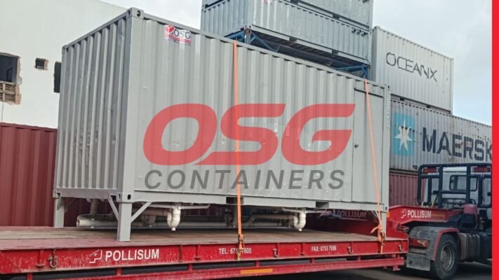 Shipping containers stacked on a flatbed truck, ready for transport.