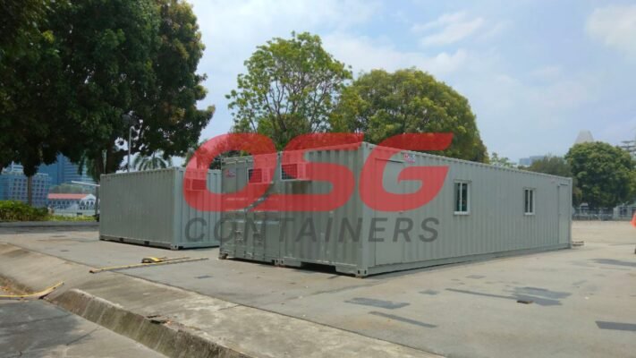 Several shipping containers are set up as modular buildings outdoors.