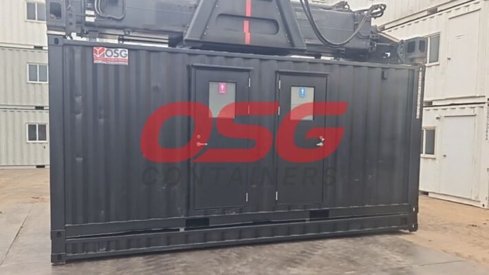 A black shipping container with two doors and windows.