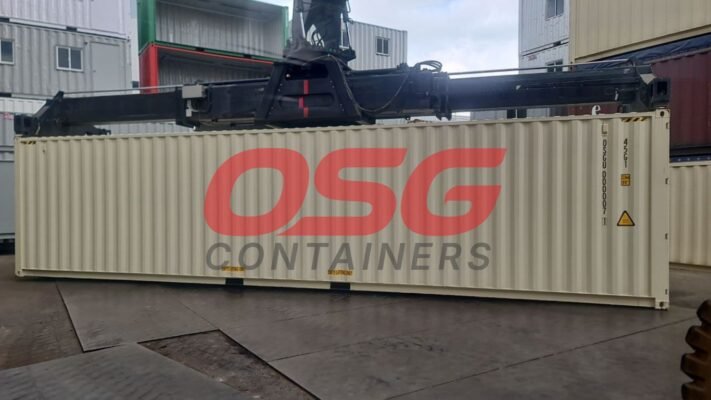 A crane lifts a shipping container with OSG Containers logo.