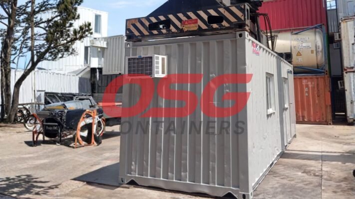 Shipping containers are stacked and arranged in an outdoor lot.