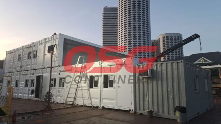 Modular container buildings stacked with a crane in the background.